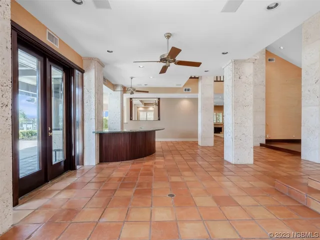 a large white kitchen with granite countertop a sink and dishwasher with white cabinets