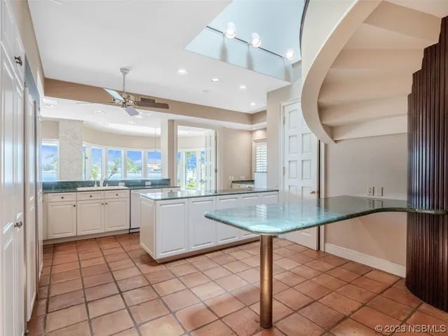 a bathroom with a sink mirror and a bathtub