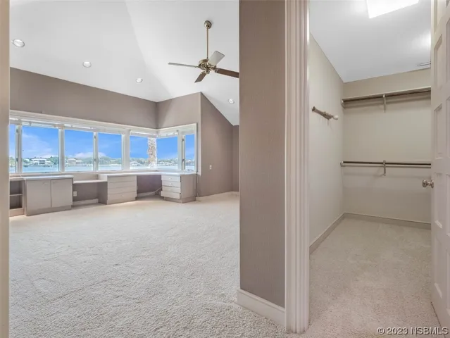 a spacious bedroom with a bed and a window