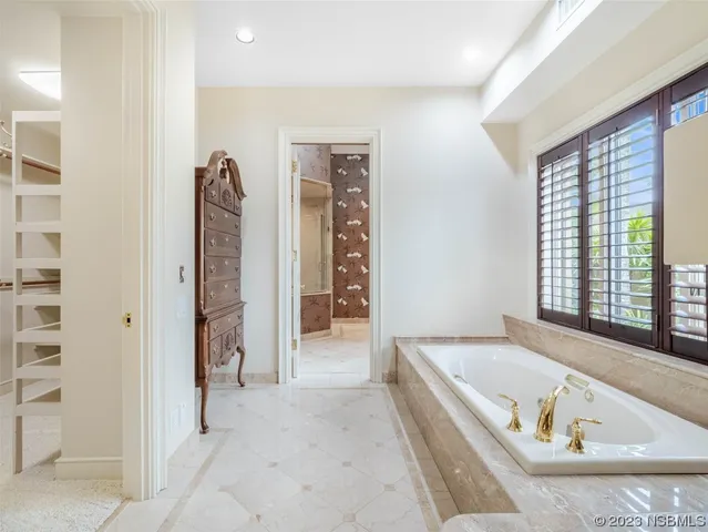 a view of a hallway with a large window and wooden floor