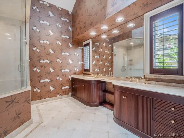 a bathroom with a granite countertop sink mirror and toilet