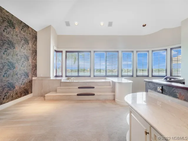 a view of a livingroom with a fireplace and a ceiling fan
