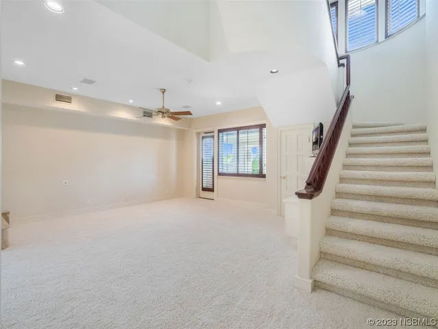 a view of a house with a swimming pool and sitting area