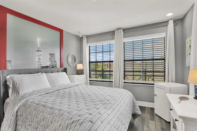 a bedroom with a large bed and a large window