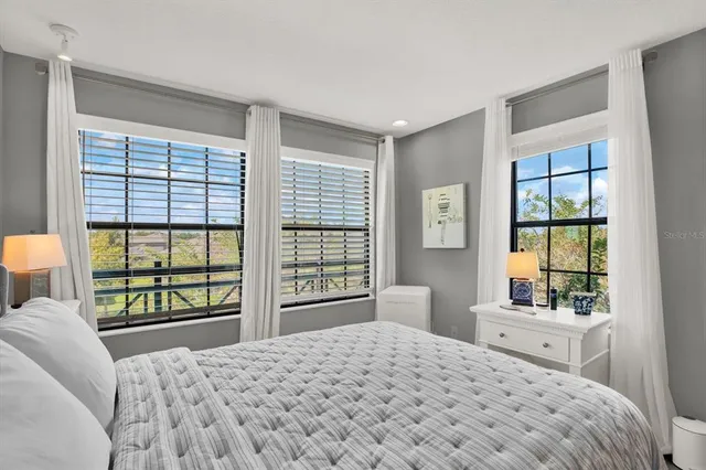 a bedroom with a large bed and a large window