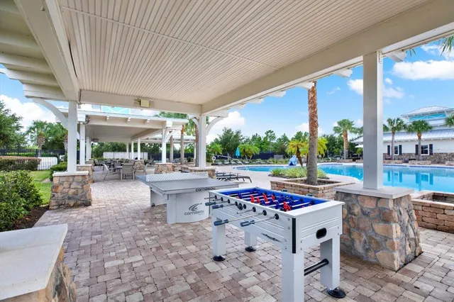 a view of a patio with a dining table and chairs