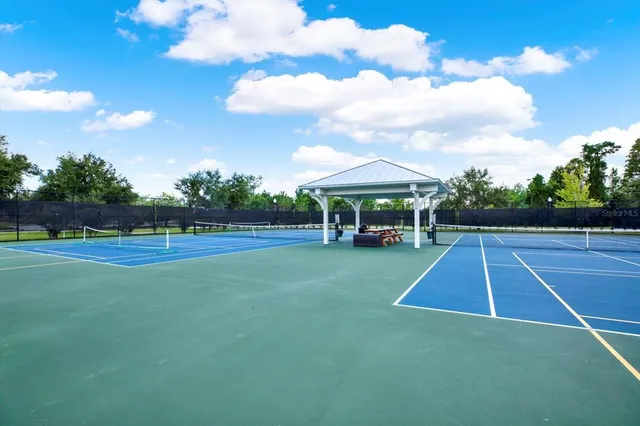 a view of backyard with swimming pool and green space
