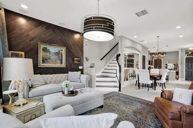 a living room with furniture and a chandelier