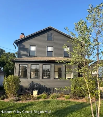 a front view of a house with a garden