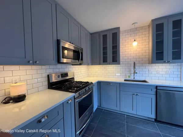 a kitchen with sink cabinets and microwave