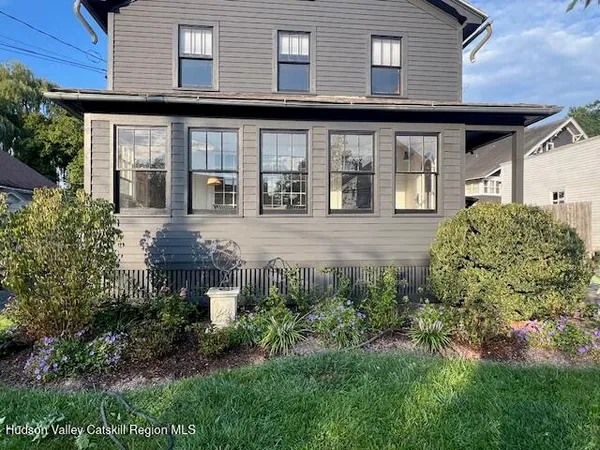 a front view of a house with garden