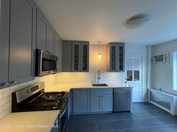 a kitchen with a sink a stove and cabinets
