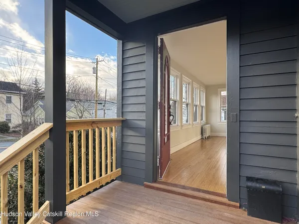 a view of a porch with wooden floor and a porch