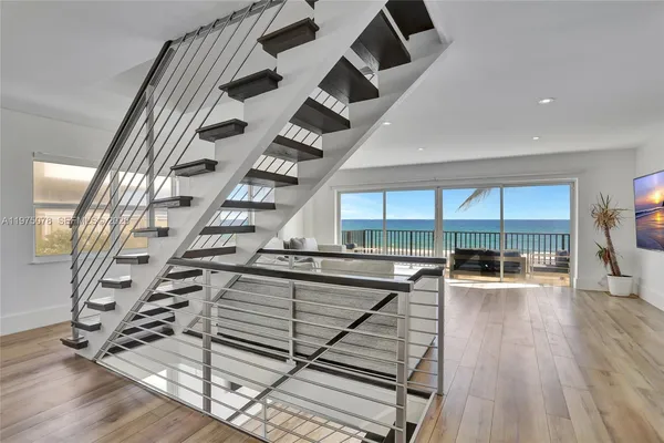 a living room with furniture and a floor to ceiling window
