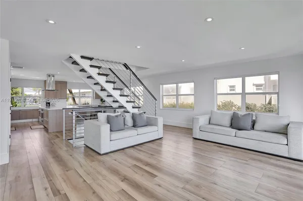a dining room with furniture and wooden floor