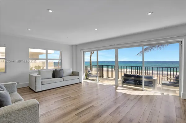 a large kitchen with stainless steel appliances a large window and a counter space