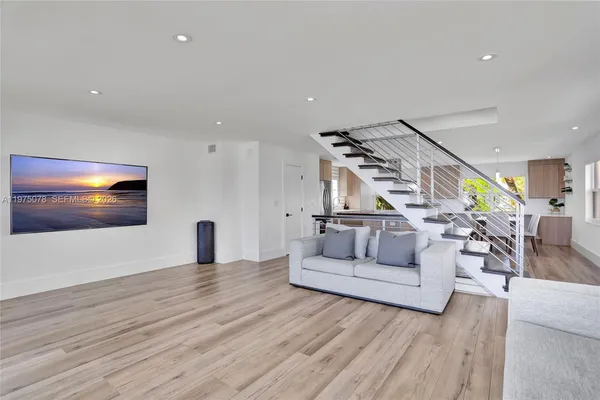 a kitchen with stainless steel appliances cabinets and a large window