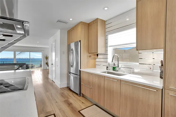 a kitchen with a sink cabinets and wooden floor