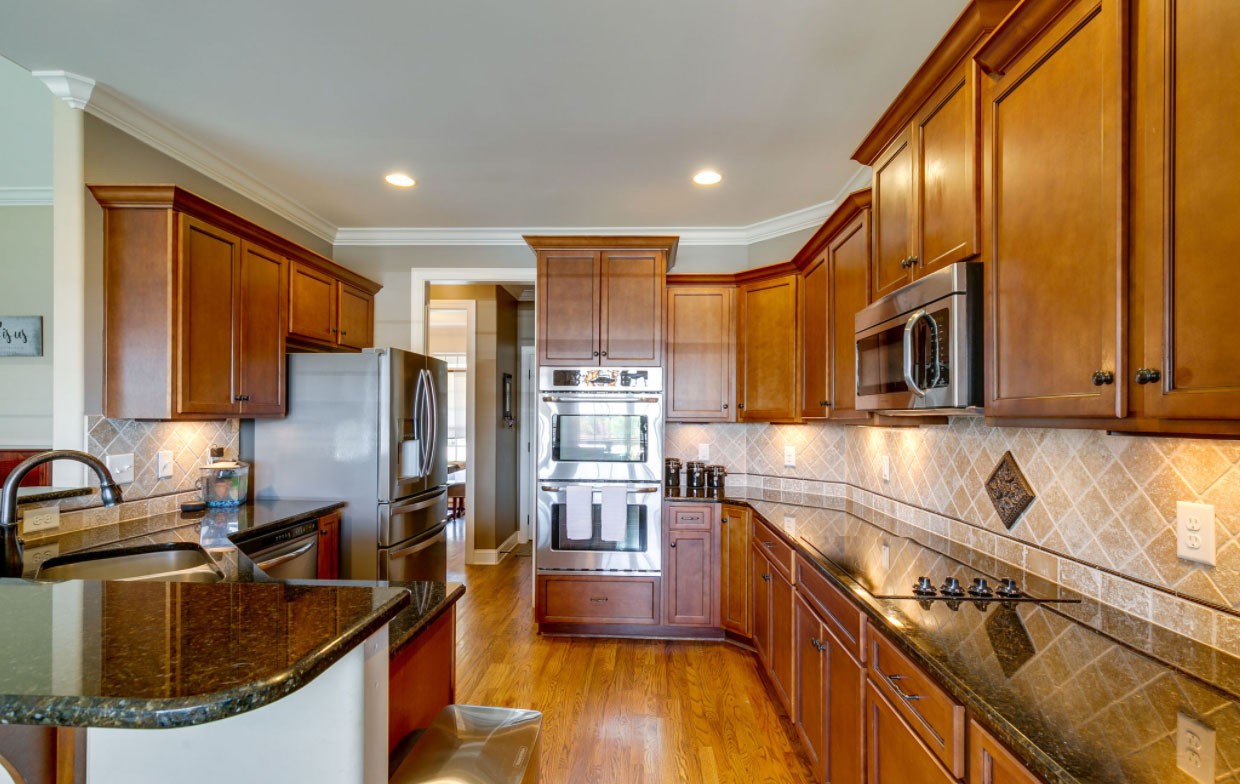 3103 Sakari Circle Spring Hill, TN 37174 - Photo 5 of 18 a kitchen with stainless steel appliances granite countertop a sink stove and refrigerator