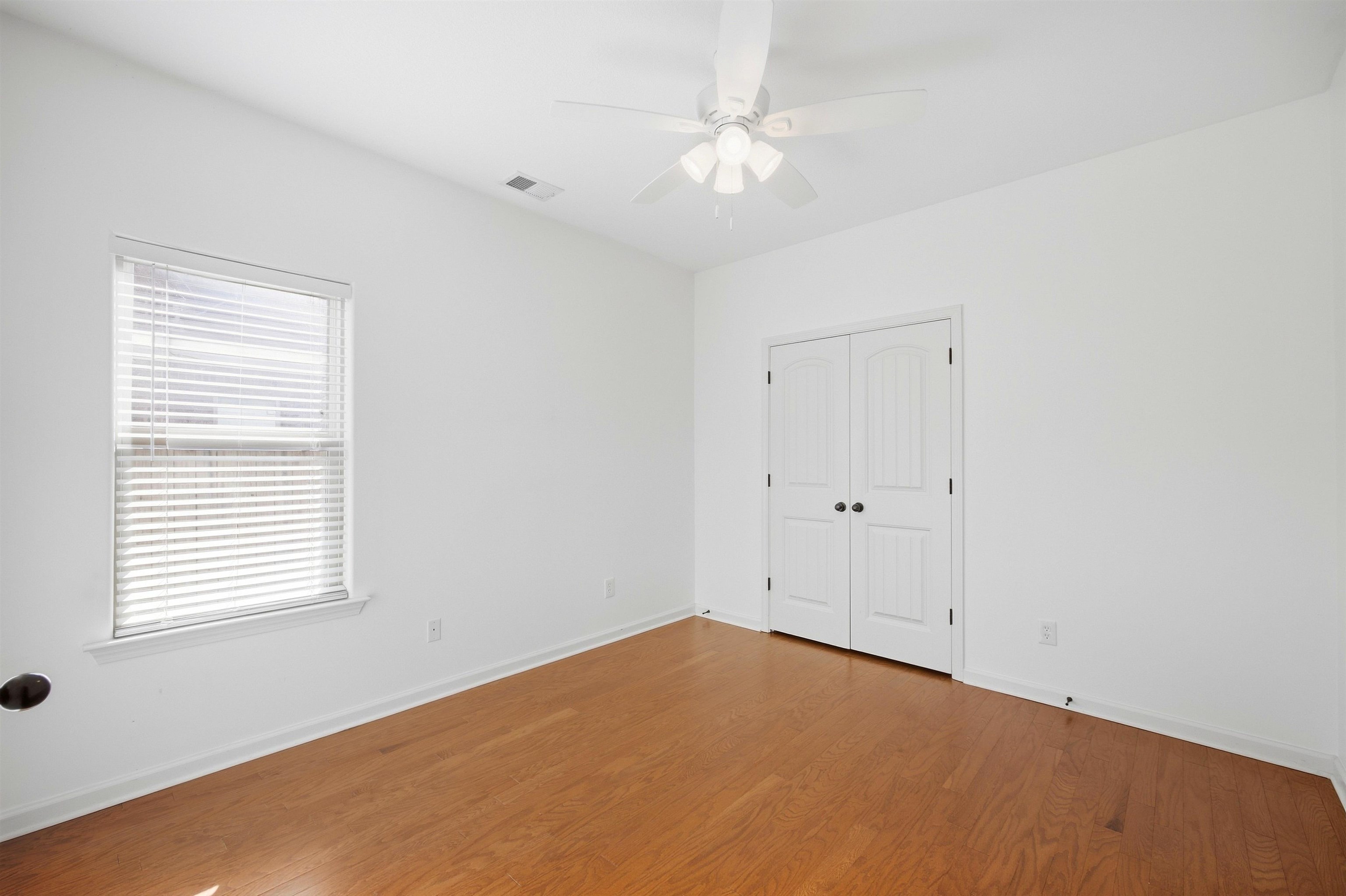 7920 Pips Ridge Lane Bartlett, TN 38133 - Photo 26 of 40 Wood-finish flooring with white walls and a ceiling fan