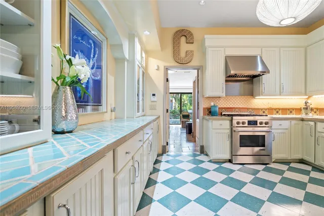 a kitchen with stainless steel appliances granite countertop a stove a sink and a granite counter tops
