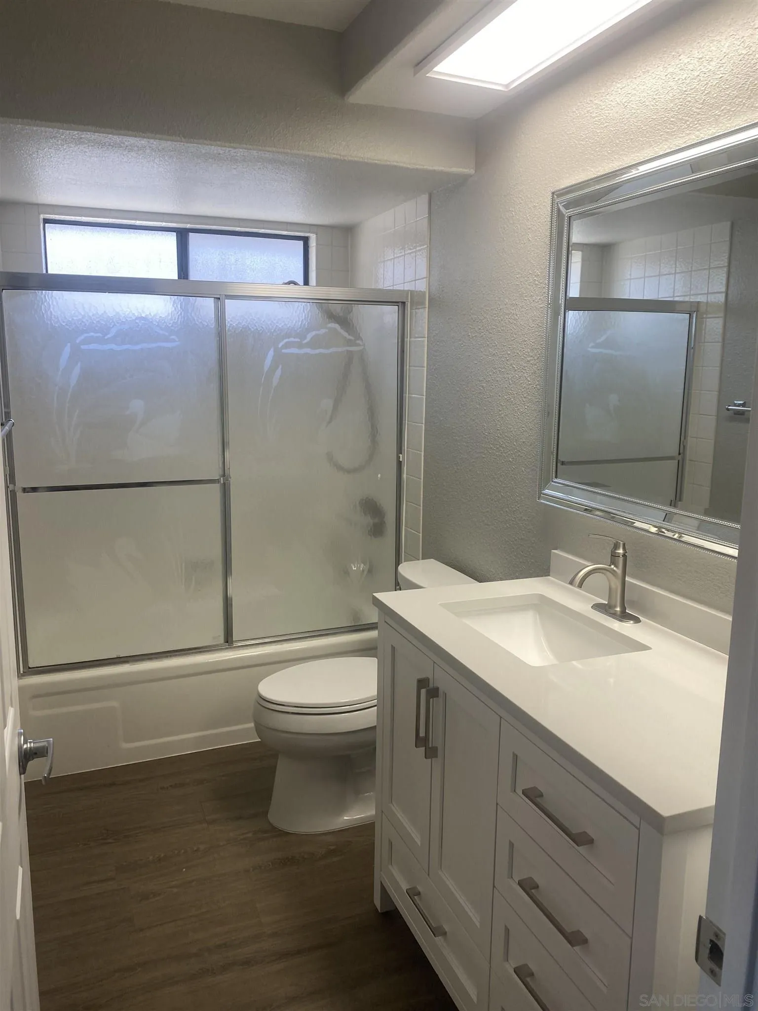 10991 Hillcreek Road Santee, CA 92071 - Photo 18 of 26 a bathroom with a sink a toilet and shower