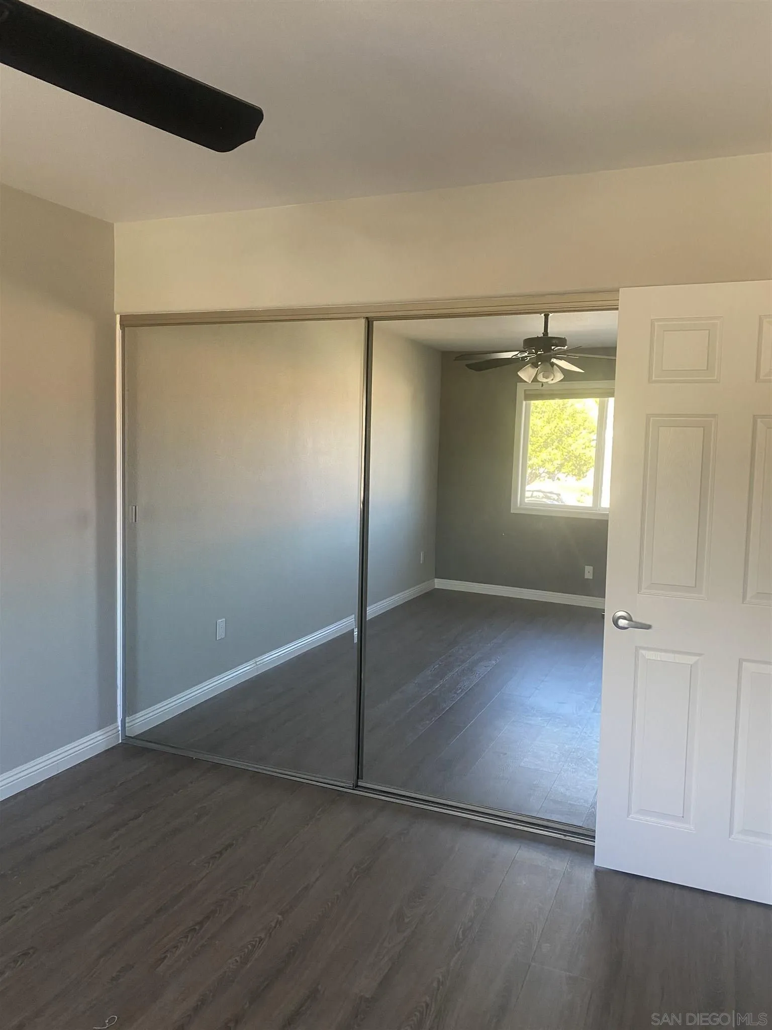 10991 Hillcreek Road Santee, CA 92071 - Photo 20 of 26 an empty room with wooden floor closet and windows