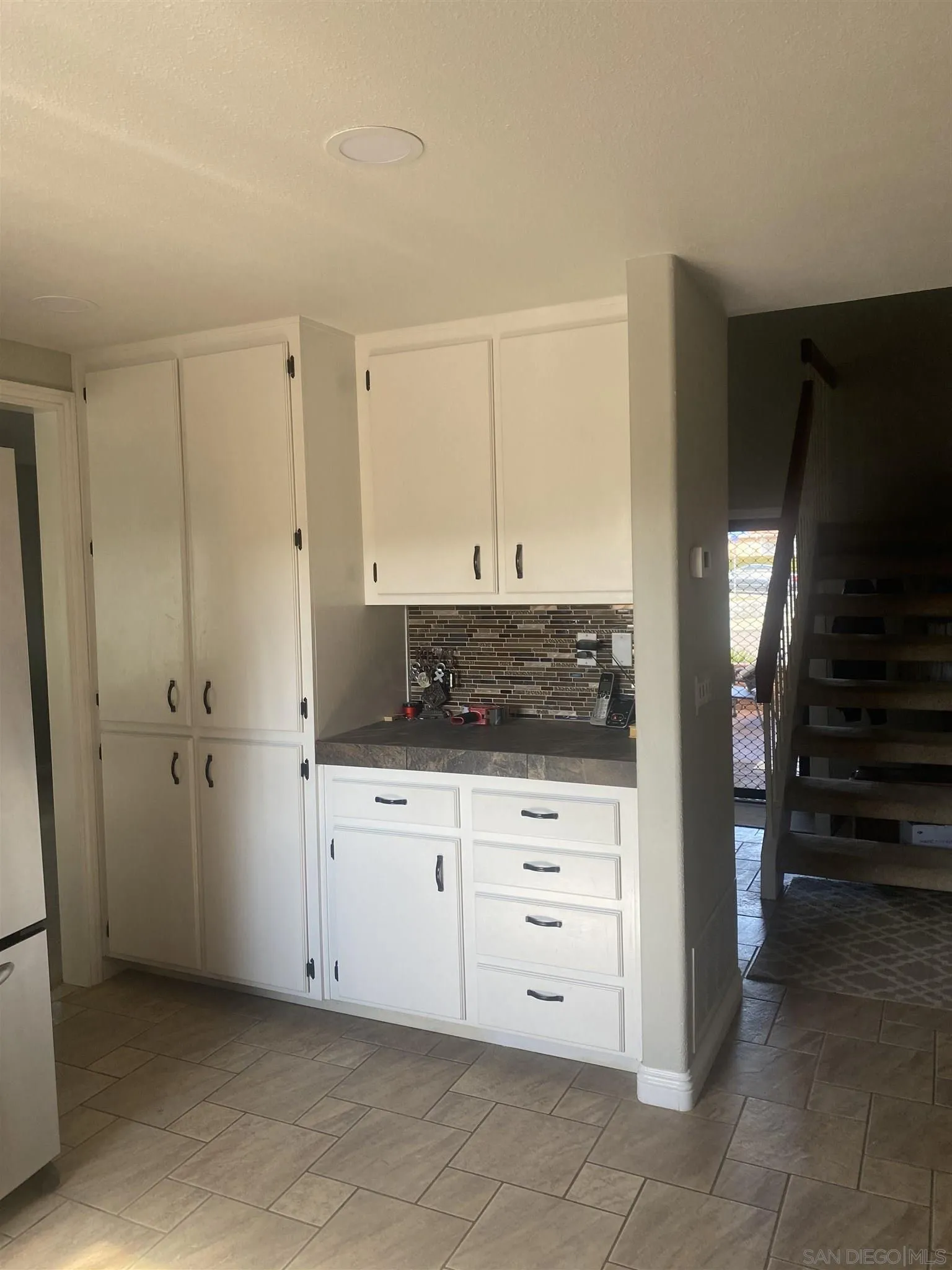 10991 Hillcreek Road Santee, CA 92071 - Photo 26 of 26 a kitchen with white cabinets