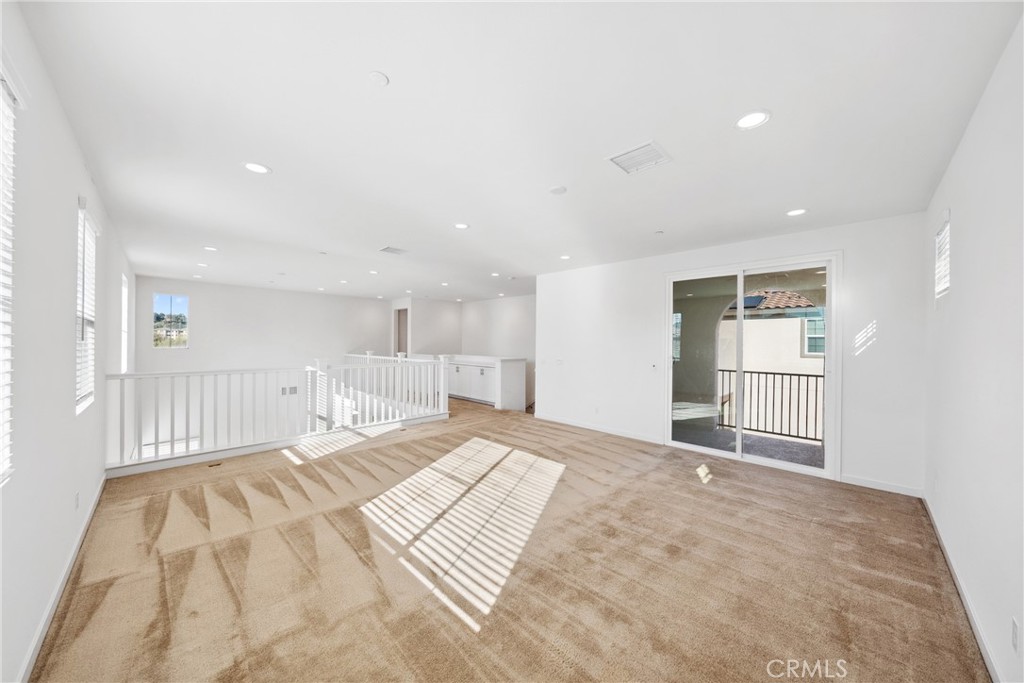 45037 Via Vela Temecula, CA 92592 - Photo 15 of 38 a view of a bedroom with a bed and wooden floor