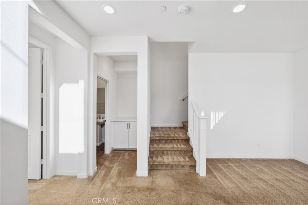 45037 Via Vela Temecula, CA 92592 - Photo 17 of 38 an empty room with wooden floor and white doors