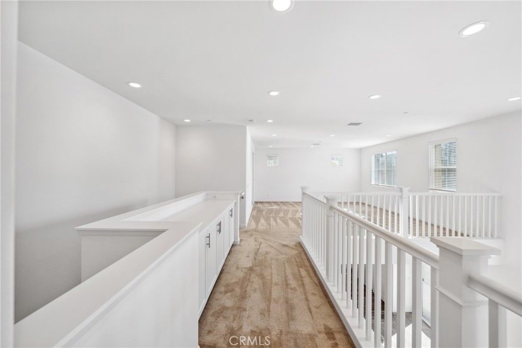 45037 Via Vela Temecula, CA 92592 - Photo 18 of 38 a view of a hallway with wooden floor