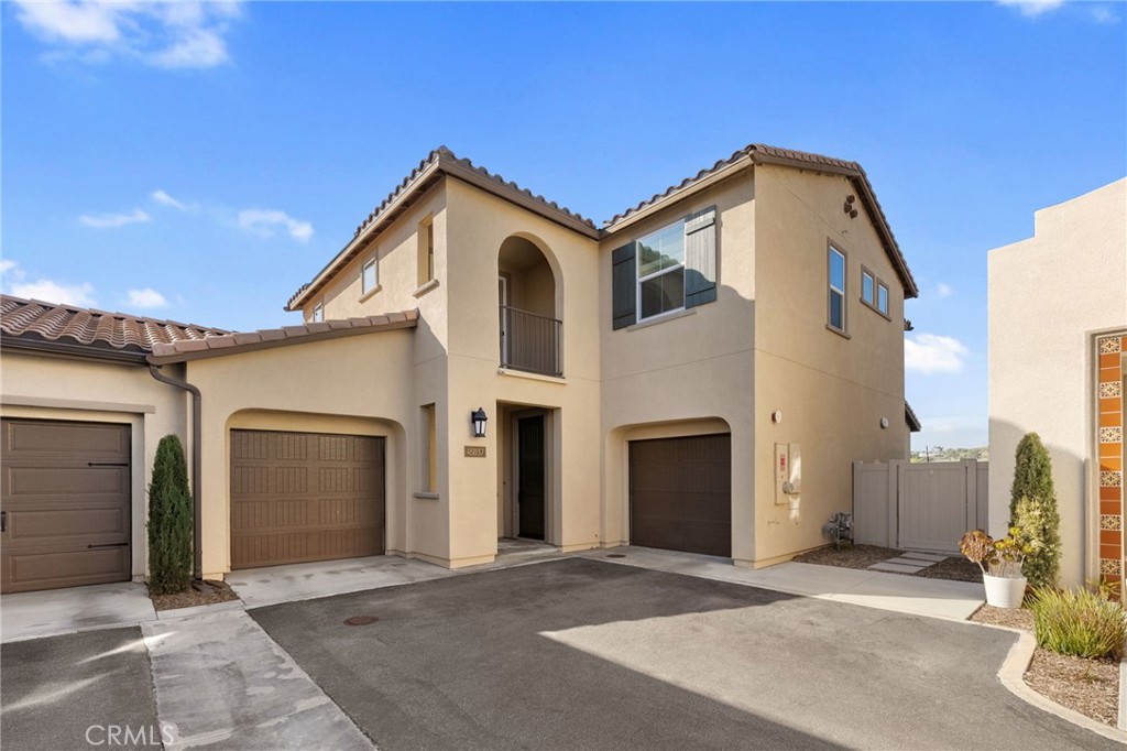 45037 Via Vela Temecula, CA 92592 - Photo 32 of 38 a view of a grey house with a garage and balcony