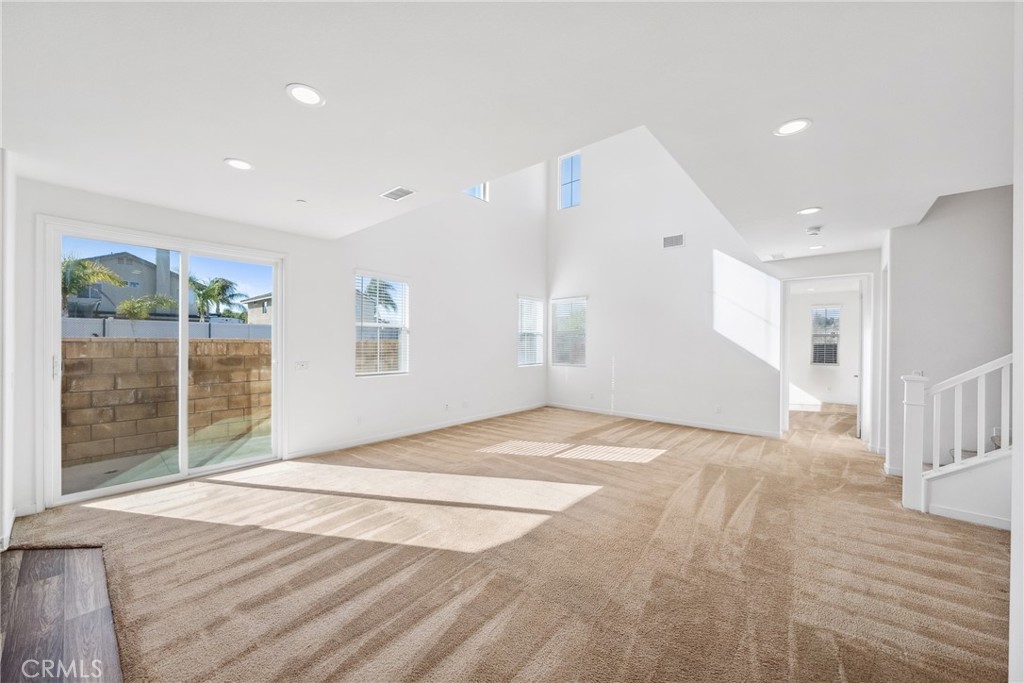 45037 Via Vela Temecula, CA 92592 - Photo 9 of 38 a view of an empty room with wooden floor and a window