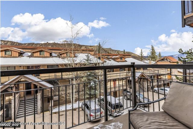 a view of a balcony with an outdoor seating
