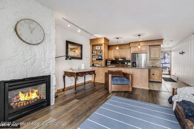 a living room with furniture and kitchen view