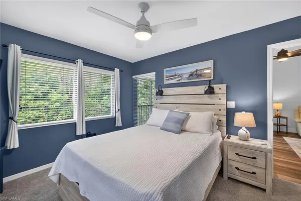 a bedroom with a large bed and a window