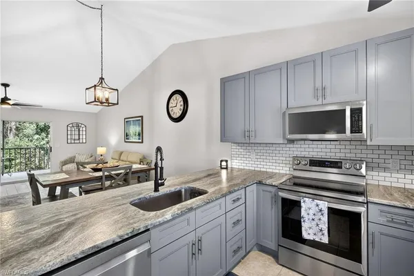 a kitchen with cabinets appliances and a sink
