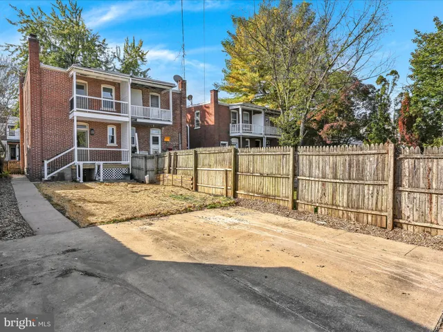 a view of a house with a wooden fence