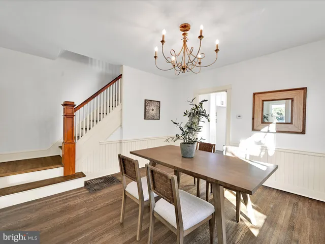 a view of a dining room with furniture wooden floor and chandelier