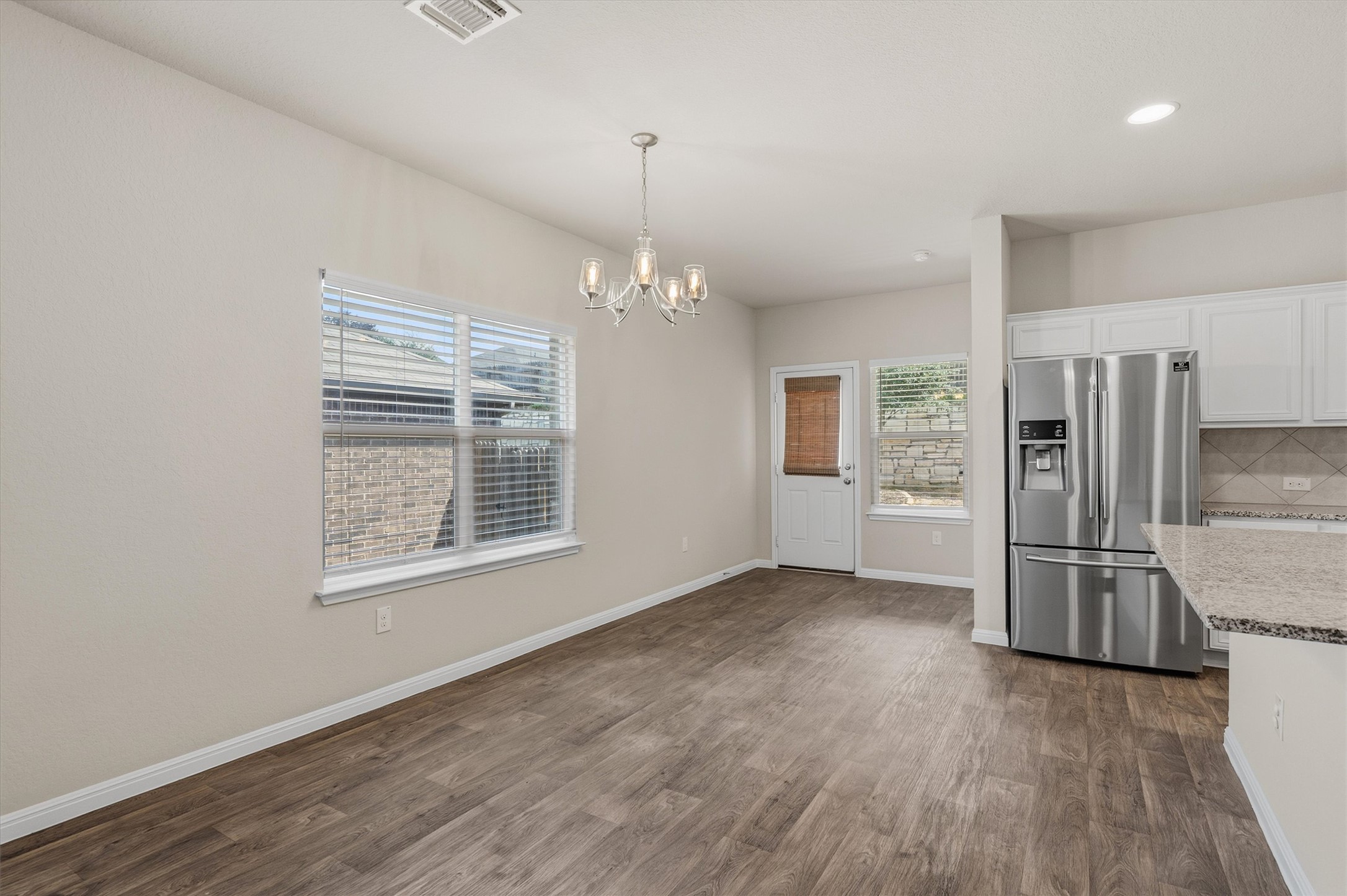 10817 Gonzales Ranger Pass Austin, TX 78754 - Photo 11 of 37 Right off the kitchen is your dedicated dining space. You have direct access to the back patio, making it perfect for moving outdoors when you're grilling!