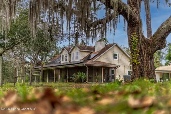 a backyard of a house with lots of trees