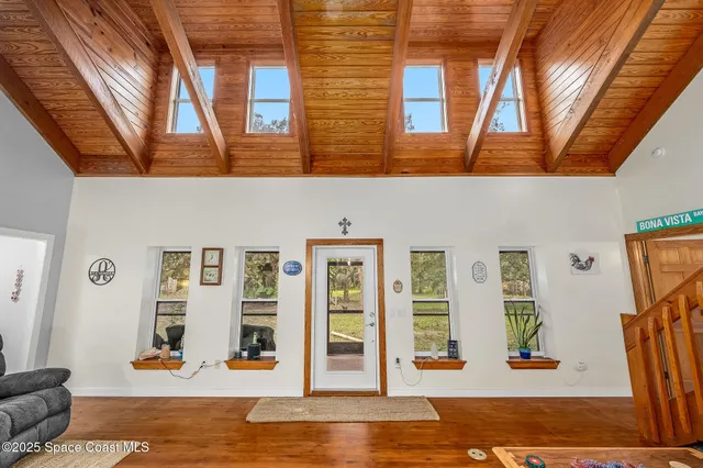 a utility room with stainless steel appliances kitchen island granite countertop a sink and cabinets