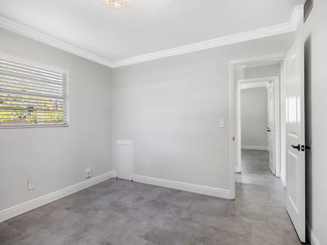 an empty room with windows and closet