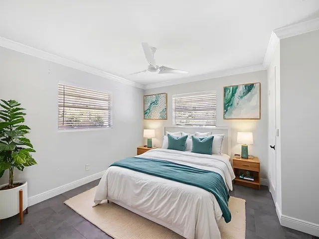 a bedroom with a bed and a potted plant