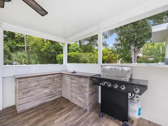 a view of a livingroom with a ceiling fan and wooden floor