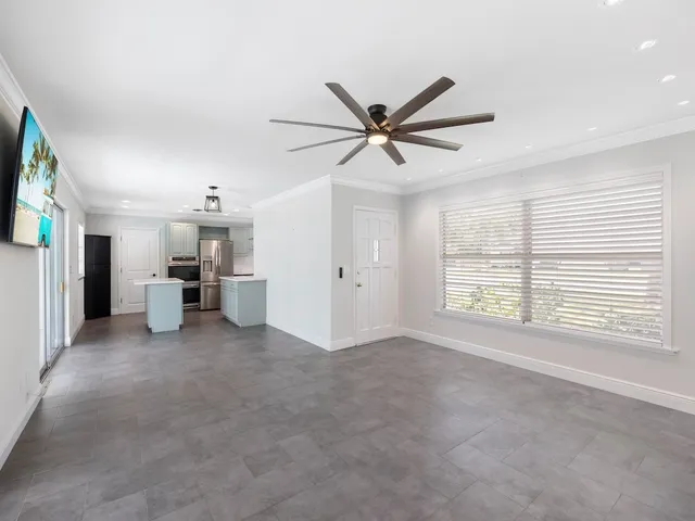 a view of a livingroom with a ceiling fan and window