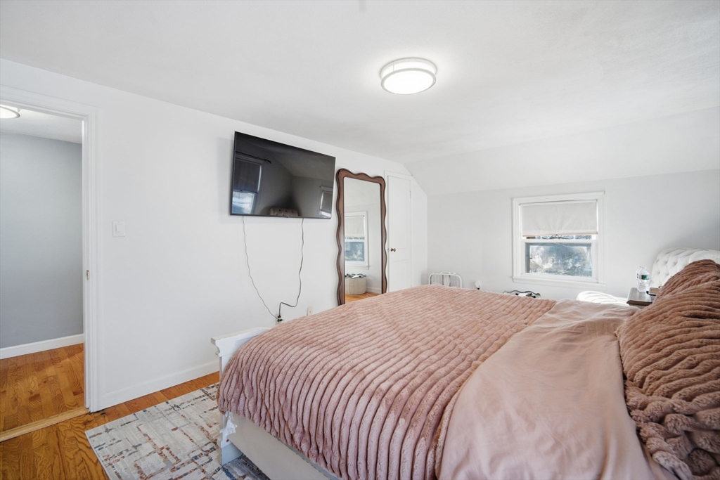 13 Bither Street Springfield, MA 01118 - Photo 15 of 29 a bedroom with a bed and a flat screen tv