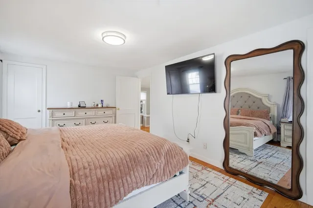 a bedroom with a bed and a mirror