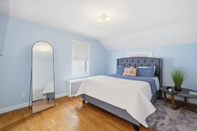 a bedroom with a bed and window