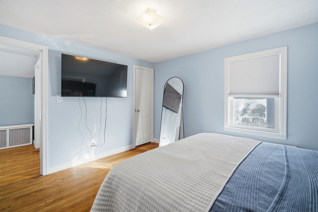 13 Bither Street Springfield, MA 01118 - Photo 19 of 29 a bedroom with a bed and a flat screen tv